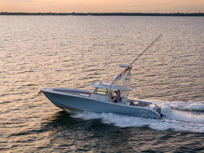 Slide: The Image of 2022 Yellowfin 42 boat cruising on open water at sunset. - 10