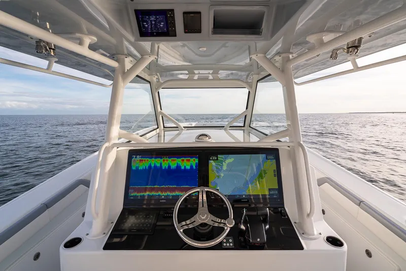 Slide: The Image of 2022 Yellowfin 42 boat helm with dual navigation screens on open water. - 16