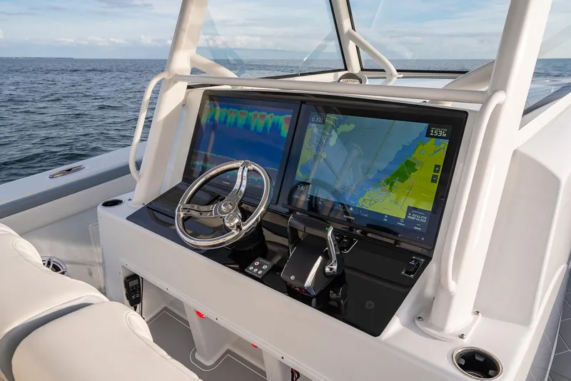 Slide: The Image of 2022 Yellowfin 42 boat dashboard with navigation screens and steering wheel. - 17