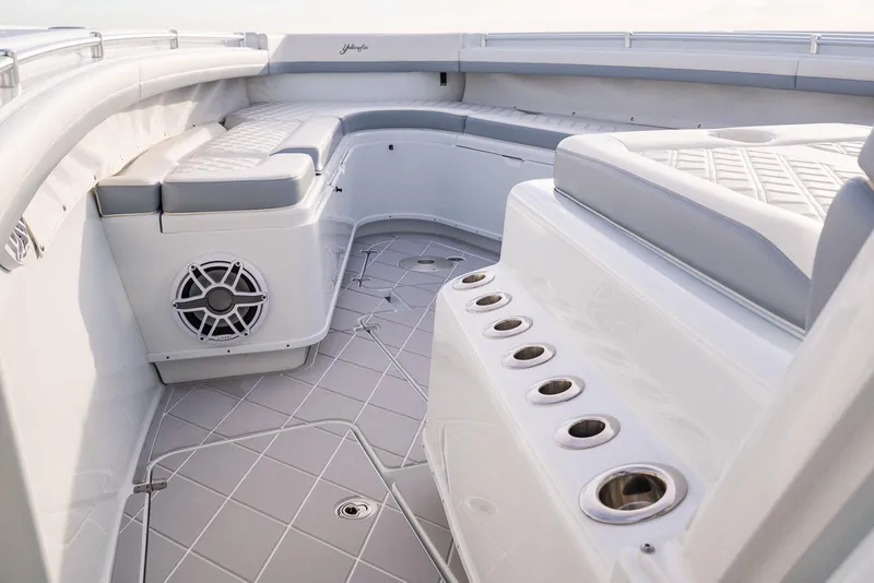 Slide: The Image of 2022 Yellowfin 42 boat interior with cushioned seating and rod holders. - 29