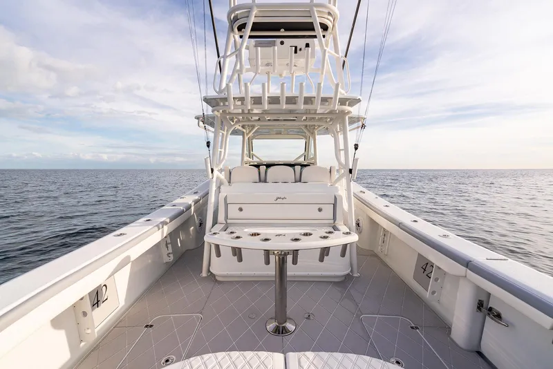 Slide: The Image of 2022 Yellowfin 42 boat on open water, showcasing spacious deck and seating. - 33