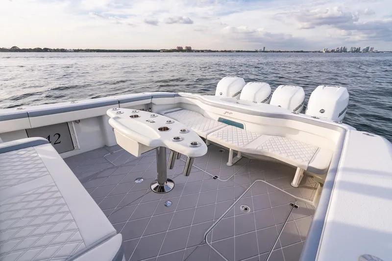 Slide: The Image of 2022 Yellowfin 42 boat with spacious seating and multiple outboard engines on the water. - 35