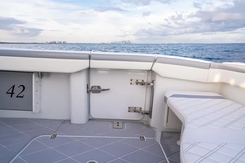 Slide: The Image of 2022 Yellowfin 42 boat deck with ocean view and city skyline in the background. - 40