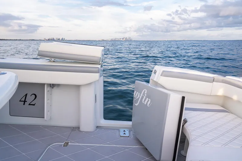 Slide: The Image of 2022 Yellowfin 42 boat on open water with city skyline in the distance. - 41