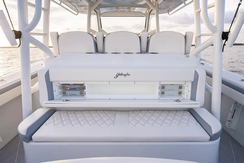 Slide: The Image of 2022 Yellowfin 42 boat interior with white cushioned seating and storage compartments. - 42