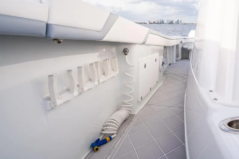 Slide: The Image of 2022 Yellowfin 42 boat deck with rod holders and coiled hose. - 47