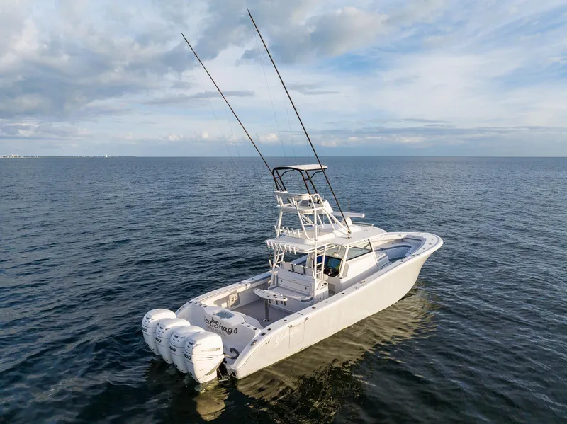 Slide: The Image of 2022 Yellowfin 42 boat with triple outboard engines on open water. - 5