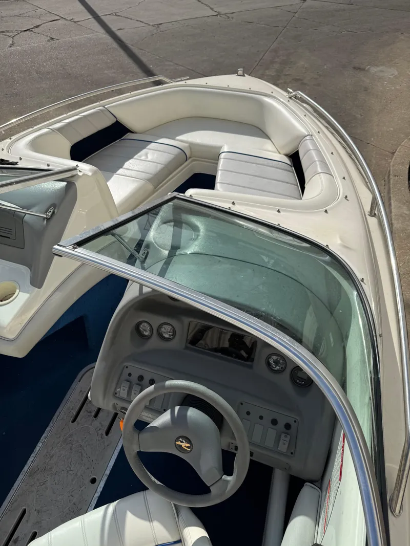 Slide: The Image of 1995 Sea Ray 180 BR boat interior with steering wheel and seating area. - 6