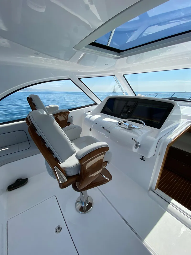 Slide: The Image of 2025 Mag Bay 42 yacht helm station with panoramic ocean view. - 13