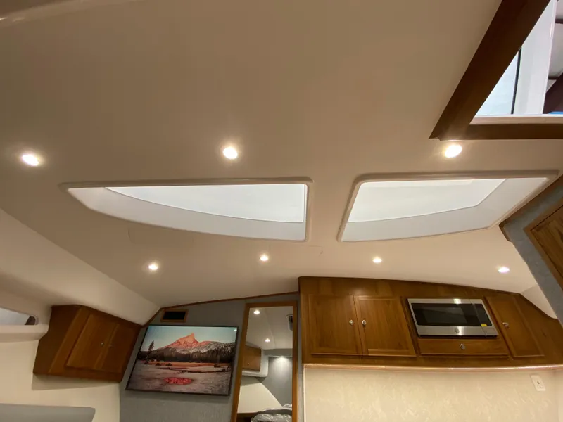 Slide: The Image of Interior of 2025 Mag Bay 42 yacht with skylights, wooden cabinets, and modern lighting. - 28