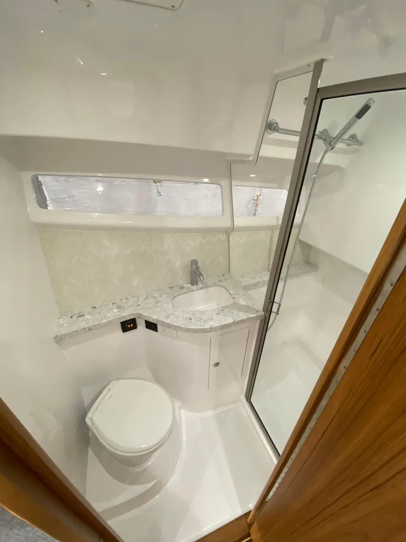 Slide: The Image of 2025 Mag Bay 42 yacht bathroom with modern fixtures and glass shower. - 31