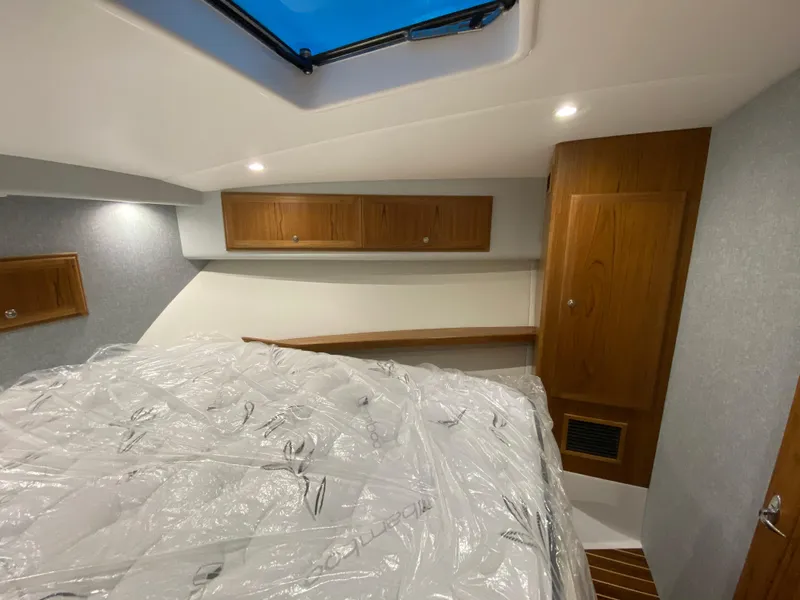 Slide: The Image of Interior cabin of 2025 Mag Bay 42 boat with wooden cabinets and bed. - 34