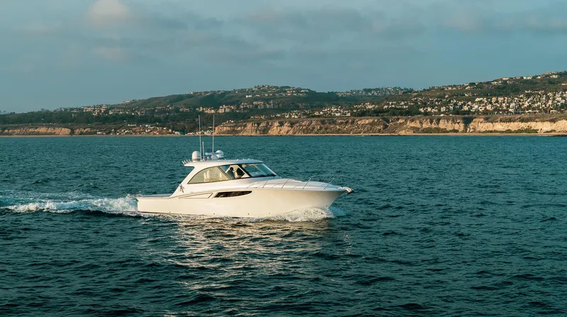 Slide: The Image of Mag Bay 42 yacht cruising on the ocean near a coastal landscape, 2025 model. - 9