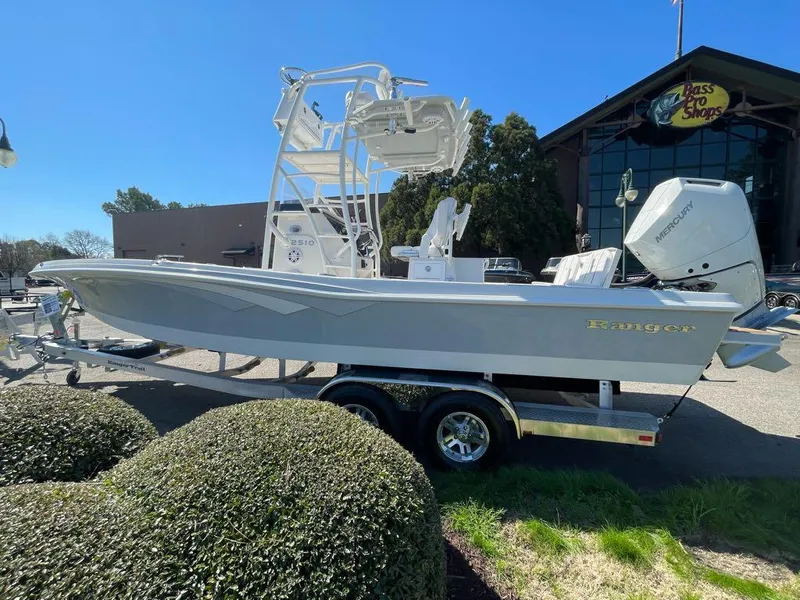 The Image of 2024 Ranger 2510 Bay boat on trailer outside Bass Pro Shops. - 0