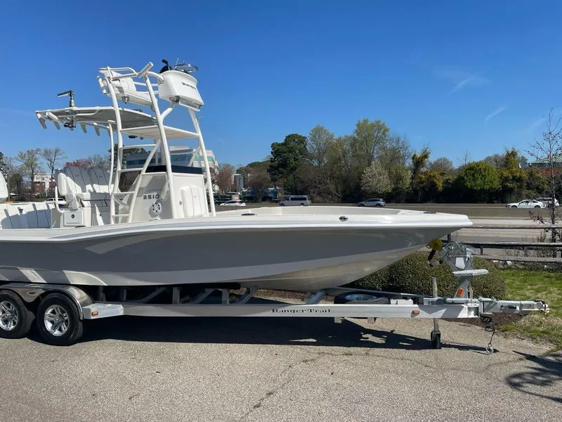 Slide: The Image of 2024 Ranger 2510 Bay boat on a trailer, side view. - 2