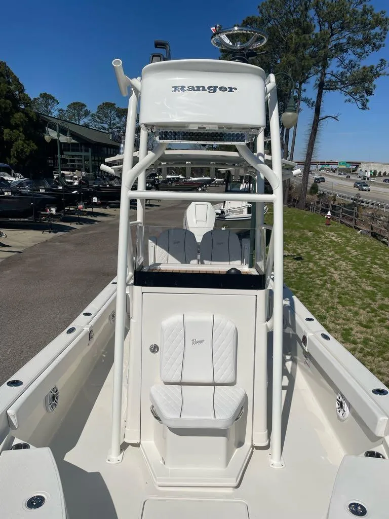 Slide: The Image of 2024 Ranger 2510 Bay boat with white seating and T-top. - 4