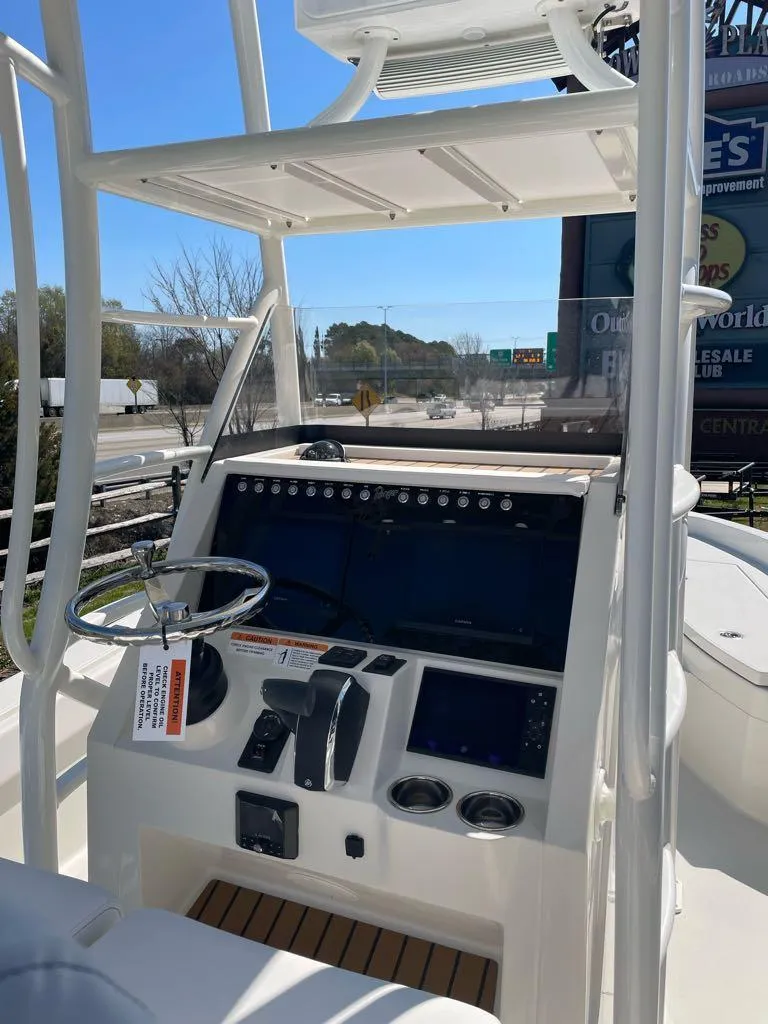 Slide: The Image of 2024 Ranger 2510 Bay boat console with steering wheel and navigation controls. - 5