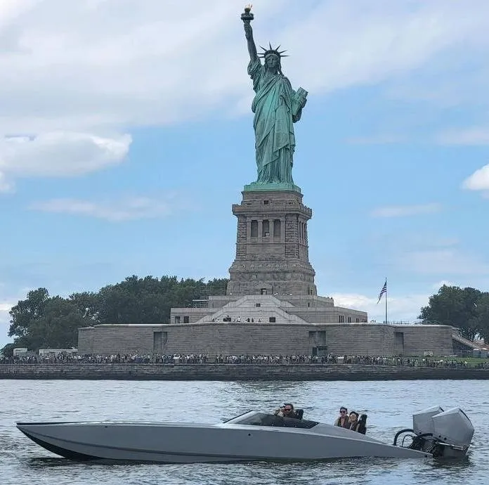 The Image of HellKats 320X speedboat in front of the Statue of Liberty, 2021. - 1