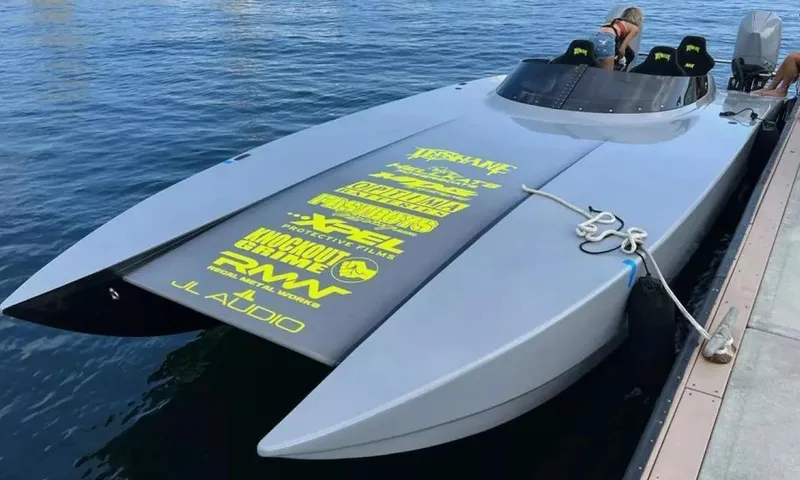 Slide: The Image of 2021 HellKats 320X powerboat docked, featuring sponsor logos on deck. - 3