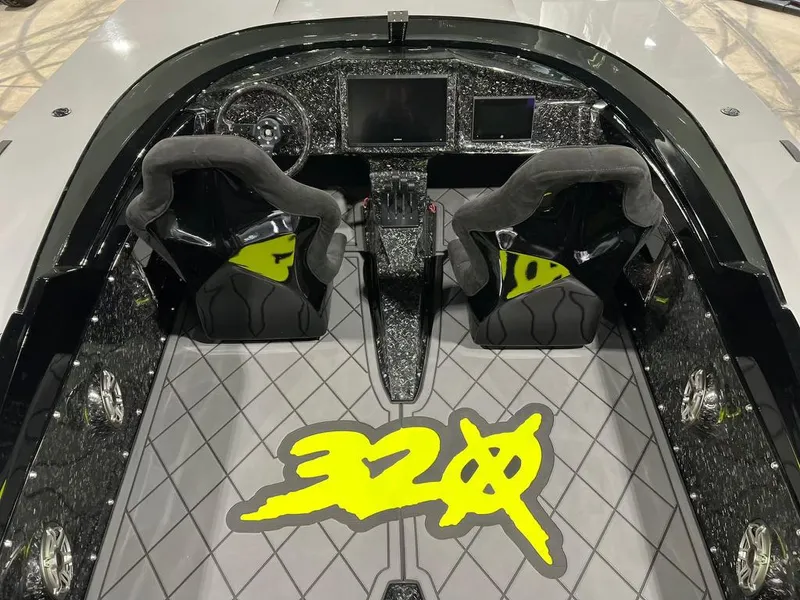 Slide: The Image of HellKats 320X 2021 model interior with dual seats and dashboard, featuring 320X logo on the floor. - 7