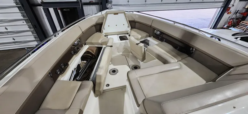 Slide: The Image of 2015 Formula 350 CBR boat interior with beige seating and cup holders. - 11