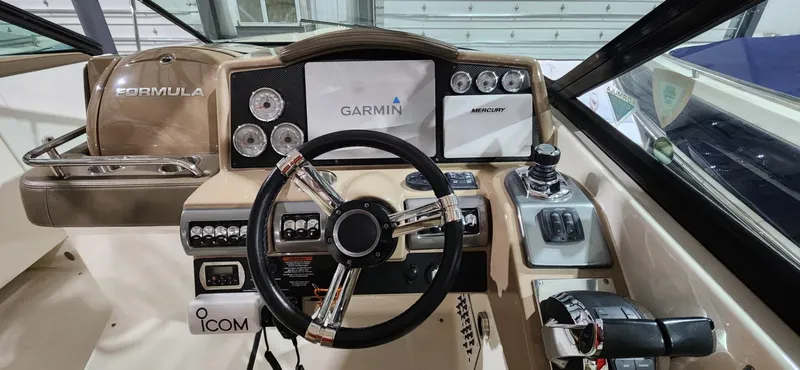Slide: The Image of 2015 Formula 350 CBR boat dashboard with Garmin navigation system and ICOM controls. - 15