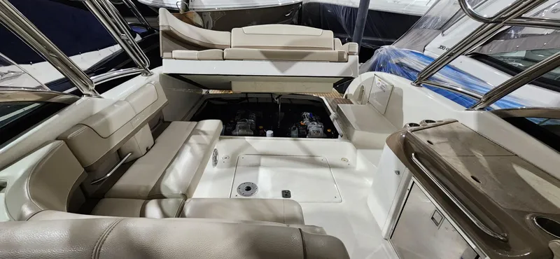 Slide: The Image of 2015 Formula 350 CBR boat interior with beige seating and open engine compartment. - 30