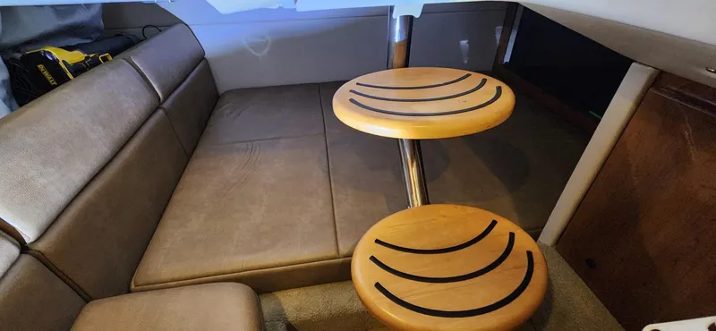 Slide: The Image of 2015 Formula 350 CBR cabin interior with brown leather seating and wooden tables. - 37