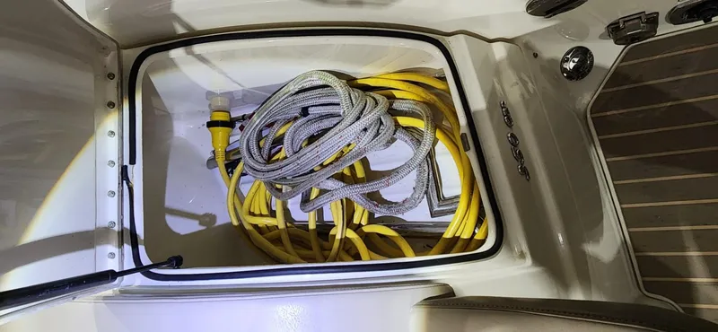 Slide: The Image of Storage compartment with coiled ropes and cables on a 2015 Formula 350 CBR boat. - 6