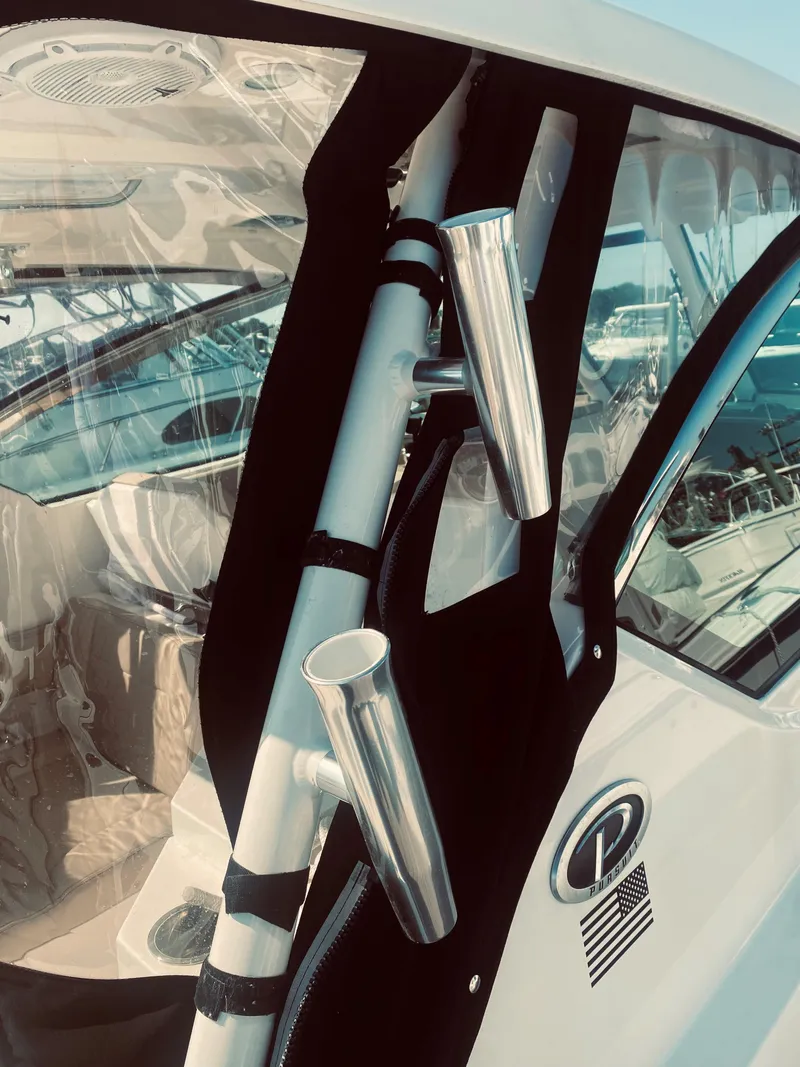 Slide: The Image of 2018 Pursuit DC 295 Dual Console boat interior with rod holders. - 3