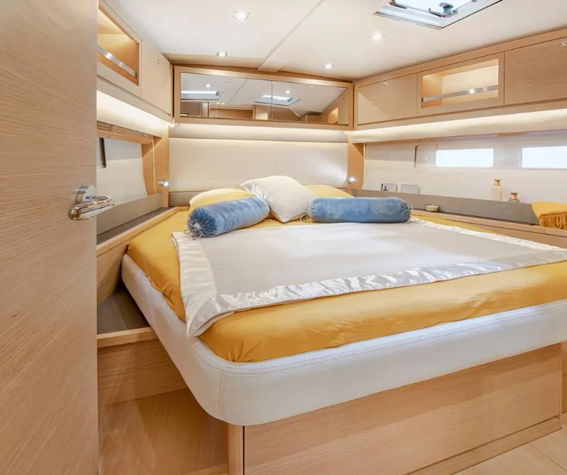 Slide: The Image of Luxurious cabin interior of 2024 Dufour 530 yacht with cozy bedding and modern design. - 5