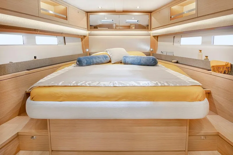 Slide: The Image of Luxurious cabin interior of 2024 Dufour 530 yacht with elegant bedding and wood finish. - 8