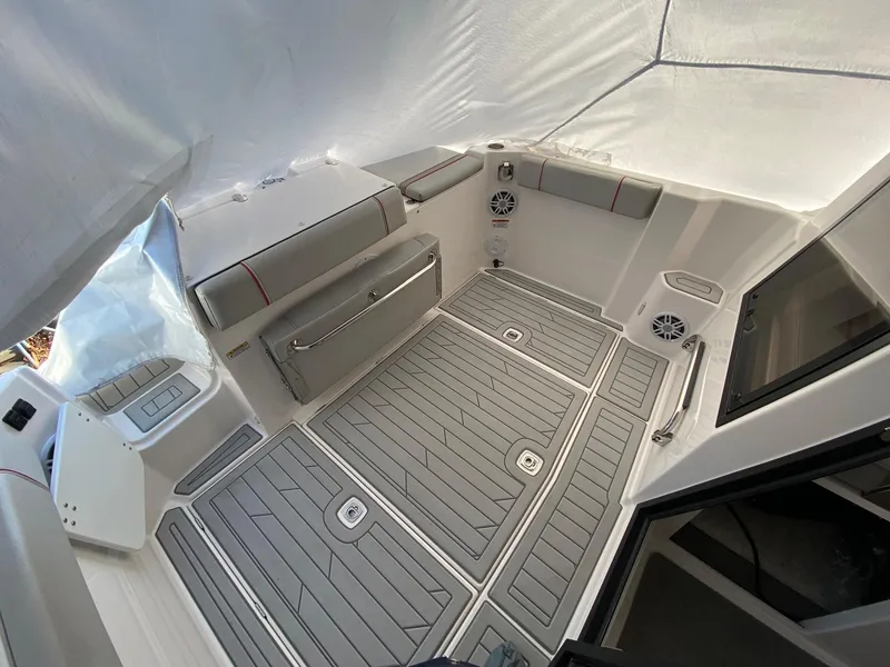 Slide: The Image of 2024 Solara S-250 C boat interior with cushioned seating and non-slip flooring. - 1