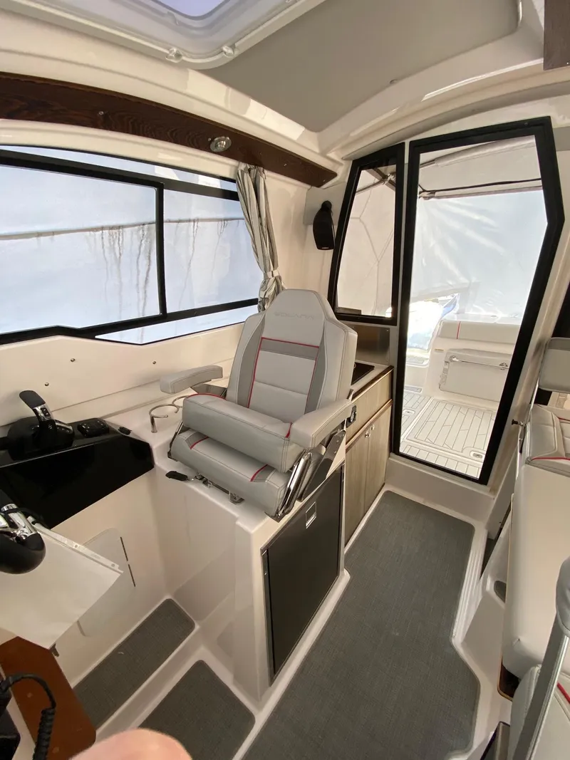 Slide: The Image of 2024 Solara S-250 C boat interior with captain's chair and control panel. - 10