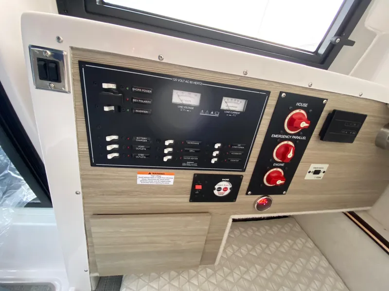 Slide: The Image of Control panel of 2024 Solara S-250 C boat with switches and gauges. - 11