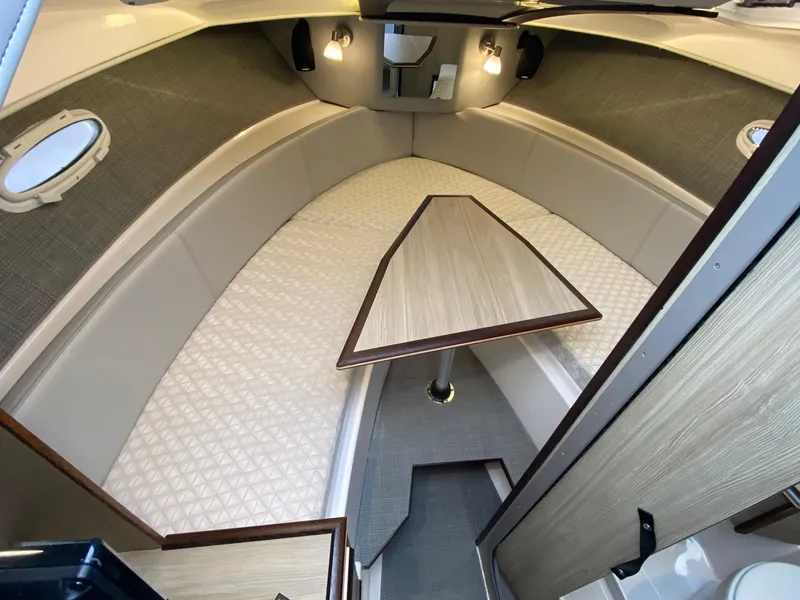 Slide: The Image of 2024 Solara S-250 C boat interior cabin with table and seating. - 18