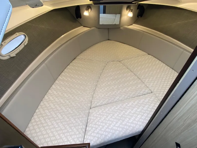 Slide: The Image of 2024 Solara S-250 C boat interior cabin with cushioned sleeping area. - 19