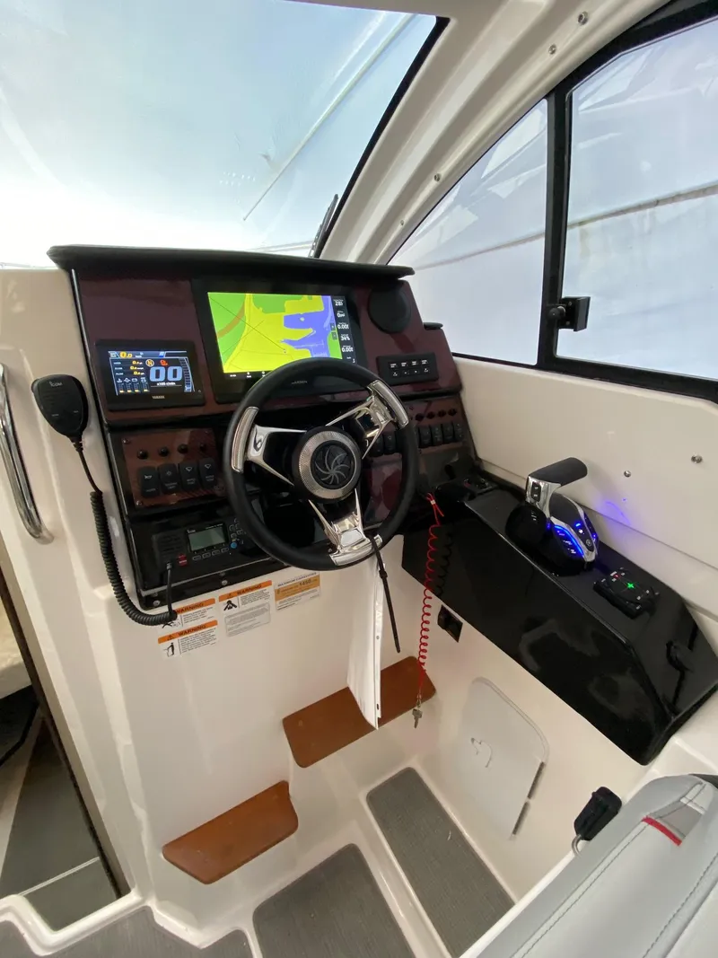 Slide: The Image of 2024 Solara S-250 C boat cockpit with advanced navigation and control systems. - 23
