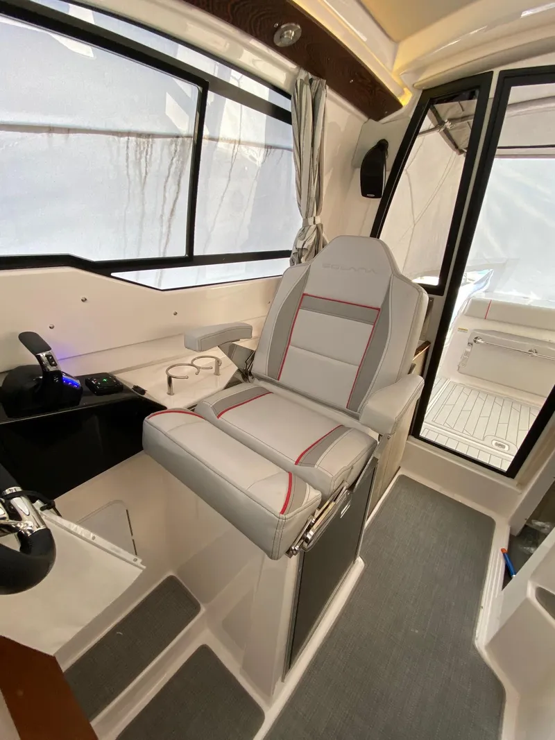 Slide: The Image of 2024 Solara S-250 C boat interior with captain's chair and control panel. - 24