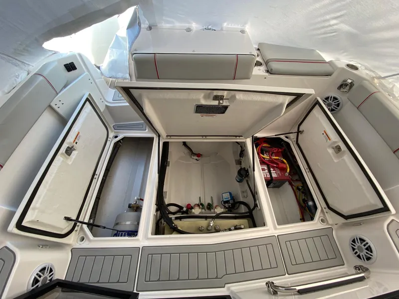 Slide: The Image of 2024 Solara S-250 C boat interior with open storage compartments and visible wiring. - 5