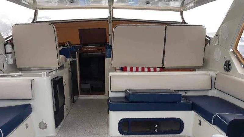 Slide: The Image of 1988 Chris-Craft 412 yacht interior with seating and cabin entrance. - 12