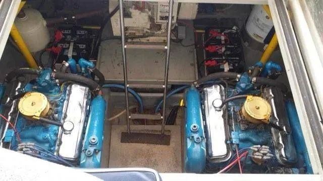 Slide: The Image of Engine compartment of 1988 Chris-Craft 412 with dual blue engines and batteries. - 13