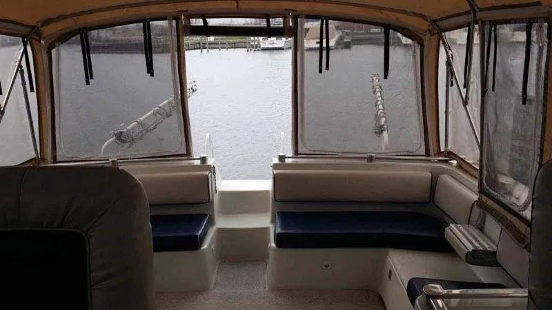 Slide: The Image of Interior view of 1988 Chris-Craft 412 yacht with marina backdrop. - 16
