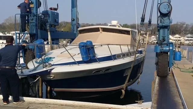 Slide: The Image of 1988 Chris-Craft 412 yacht being lifted at a marina. - 4