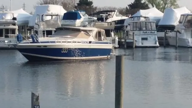 Slide: The Image of 1988 Chris-Craft 412 yacht docked in a marina with other boats. - 5