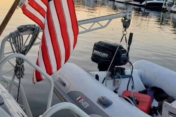 Slide: The Image of 1988 Chris-Craft 412 boat with American flag and Mercury outboard motor at marina. - 6