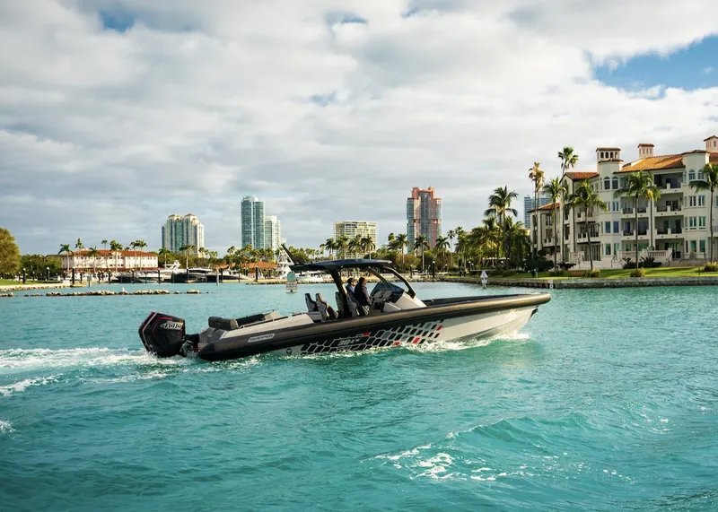 Slide: The Image of 2024 Skipper-BSK 38 boat cruising near luxury waterfront buildings - 23