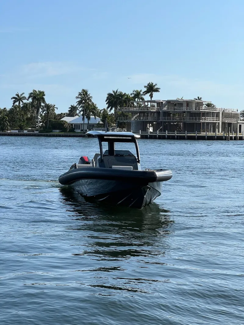Slide: The Image of 2024 Skipper-BSK 38 boat cruising on a sunny day near waterfront homes. - 3