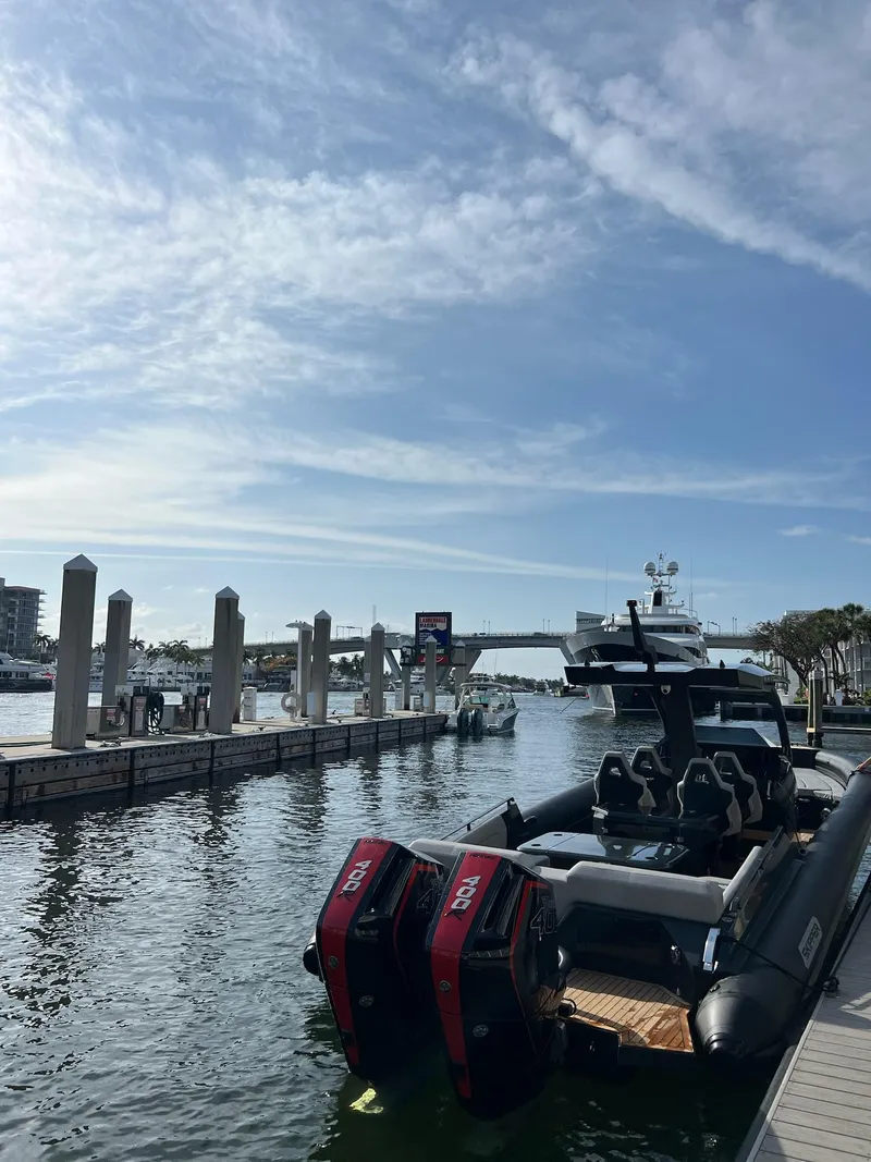 Slide: The Image of 2024 Skipper-BSK 38 boat docked at a marina under a clear blue sky. - 7
