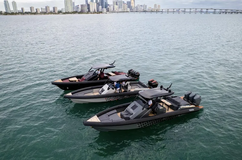 Slide: The Image of Three 2024 Skipper-BSK 38 boats on water with city skyline in background. - 16